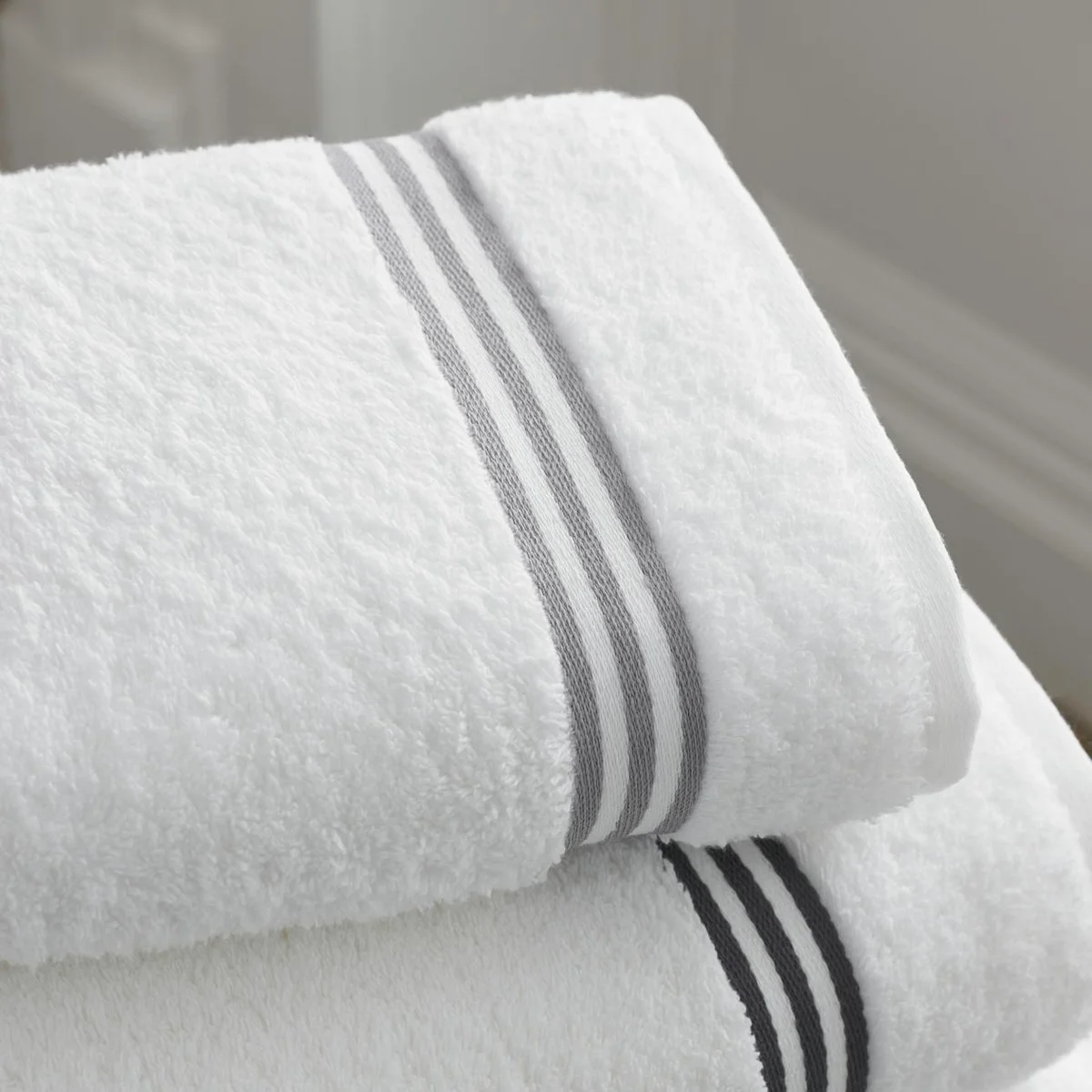 Fluffy white towels stacked for spa-like bathroom experience